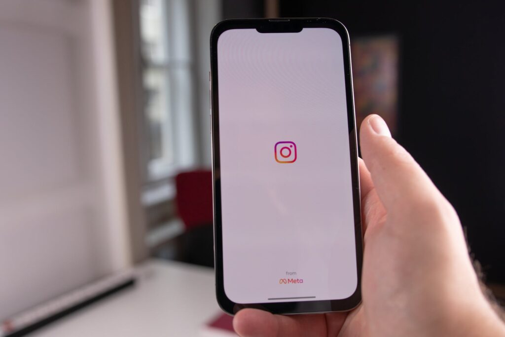 Instagram best practices; person holding a phone with Instagram logo